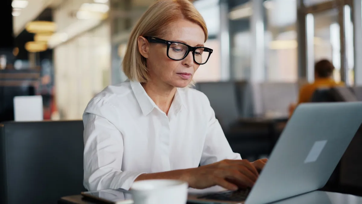 Professional bilingual copywriter reviewing Spanish and English brand content at her desk